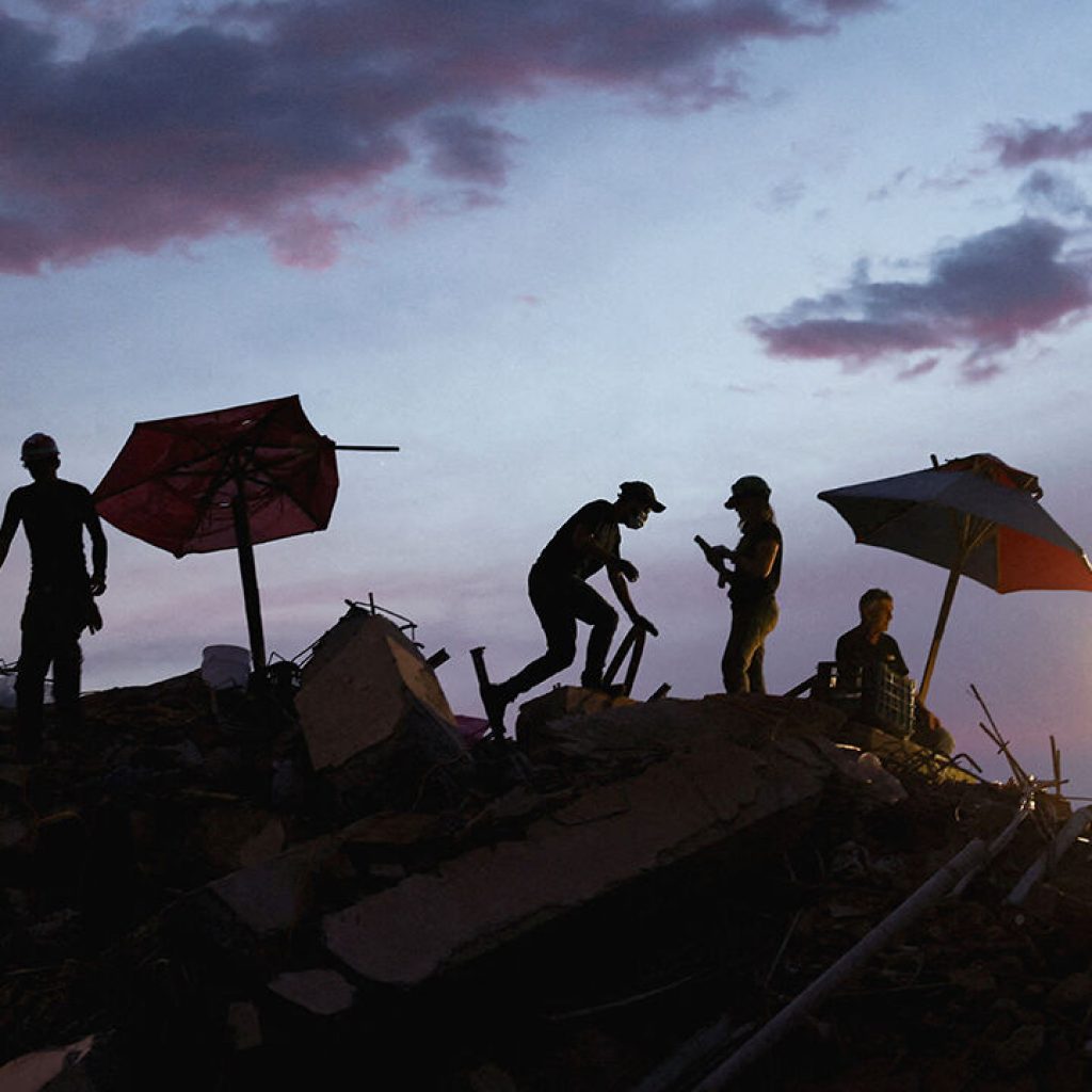 Rescuers work at the site of a collapsed building in Venezuela