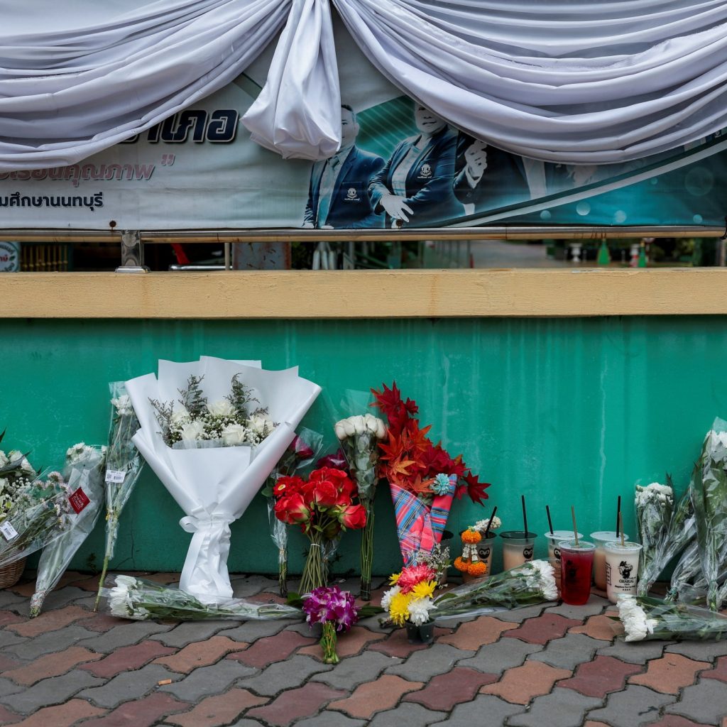 Families retrieve bodies after deadly shooting rampage
outside Bangkok