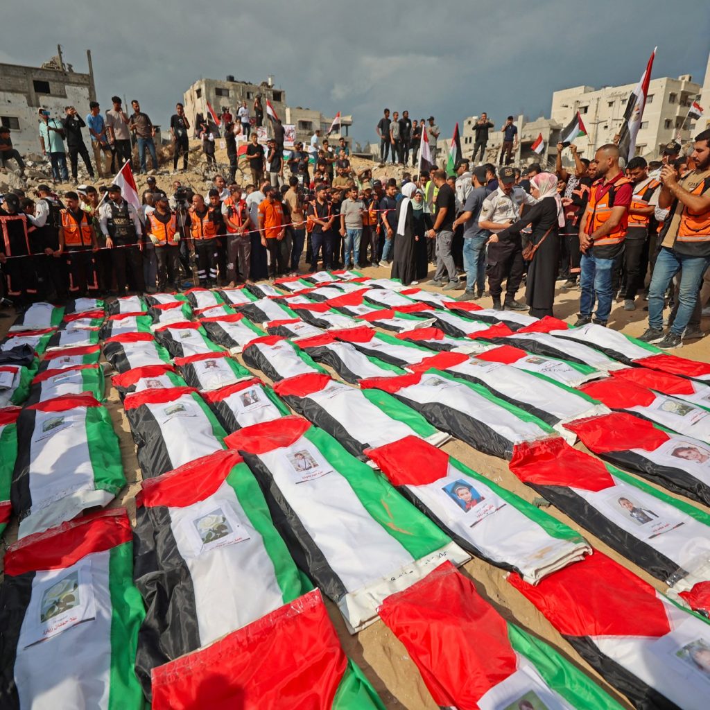 Photos: Palestinians mourn more than 100 loved ones in mass
Gaza funeral