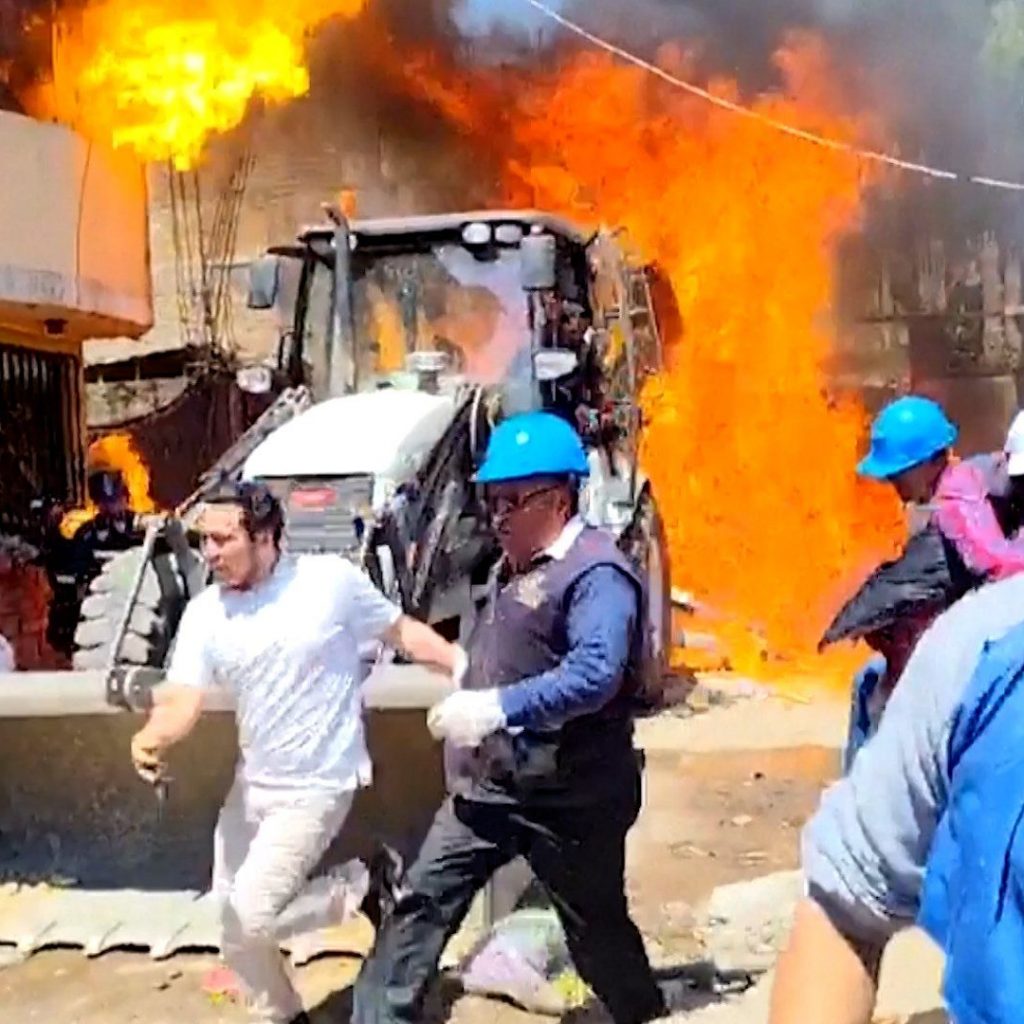 Residents douse workers with flaming gasoline during
eviction in Peru